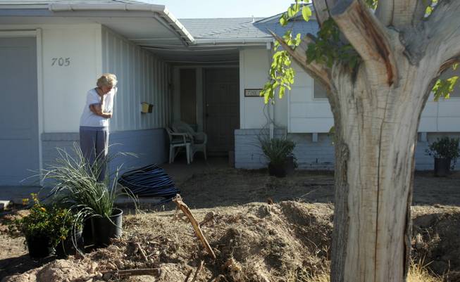 Janice Milton, 90, watches as landscapers renovate her yard. The Nevada State Contractors Board and the Nevada Landscape Association selected Milton as one of the two winners for the "Operation Green" yard makeover program.