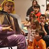 Librarian Elaine Gibbon reads "Where's My Mummy?" to mesmerized children during storytime at the Boo! Boo! Halloween Pajama Party at Enterprise Library on Monday.