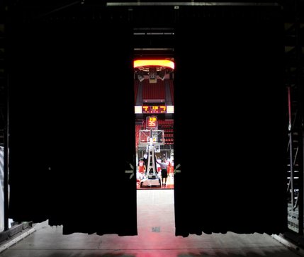 A sliver of Jerry Tarkanian court is visible from behind a curtain to the loading dock area of the Thomas & Mack Center.