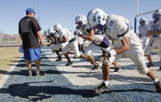 Basic High School football players run conditioning drills during practice on Monday.