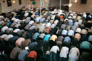 Men pray during at the Islamic Society of Nevada