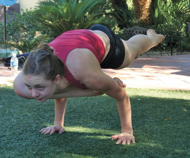 Laura Proud, 18, who has practiced bikram yoga for five years, warms up with a few asanas for the yoga championships at the annual Bishnu Ghosh Yoga competition at Town Square Park on Sunday.