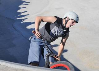 Advanced BMX competitor Ryan Roberts reacts after botching a trick attempt on the lip of a bowl during the Las Vegas AmJam skatepark series finals at Doc Romeo park on Saturday.