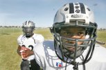 Palo Verde's Chaz, left, (22) and Chappel Thomas (2) pose before practice on Oct. 21. This is the first year the siblings have played on the same team.