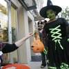 Nancy Pittman hands out candy to Ashley Cudjoe, 8, during the third annual Ghostwalk at The District at Green Valley Ranch. 