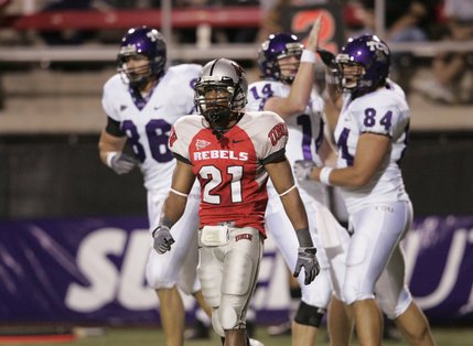 TCU players, from left, Shae Reagan, Andy Dalton and Evan Frosch celebrate after beating UNLV defensive back Lorenzo Bursey Jr. during the first half Saturday.
