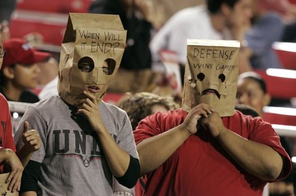 UNLV students Derik Guerrero, left, and Michael Miller wear paper bags on their heads during the first half of the Rebels' game against TCU on Saturday.
