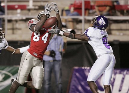 UNLV wide receiver Rodelin Anthony lets a pass drop through his hands while begin covered by TCU cornerback Alex Ibilove during the second half Saturday.