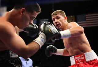 Russian Olympic middleweight boxer Matt Korobov (R) presses an attack on Mario Evangelista of Mexico during Korobov's Pro Debut at the Mandalay Bay Events Center.