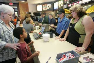 James Gibson first-grader Tyler Giles, 7, with his grandmother, Joanne Giles, left, orders chicken nuggets and a soda from his teacher, Marci Mcleod, right, and employee Amber Torsky during 'McEducator's Night' Oct. 28 at the McDonald's restaurant at the corner of Green Valley Parkway and Warm Springs Road.