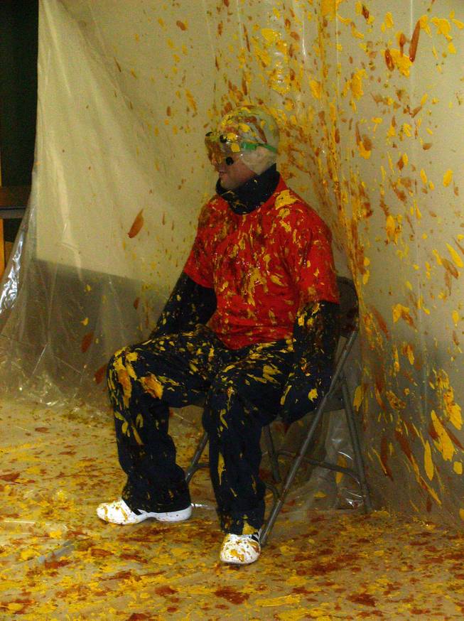 Jack Lund Schofield Middle School Principal A.J. Adams gets covered in ketchup, mustard and relish as students of all grade levels who sold 10 or more magazine subscriptions fling it from spoons during an end-of-the-day assembly Oct. 30 celebrating the fundraiser's success.            