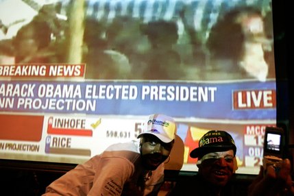 Arnena McAlister, left, and Oren Jones take photos of themselves in front of a screen projecting CNN at the Seven Seas Restaurant and Lounge in Las Vegas after the presidential election is called for Barack Obama on Tuesday.