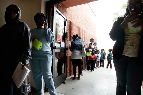 A small line extends out the door in the early ...