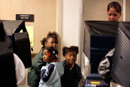 Rovonda Moore, right, 28, votes with her two daughters and their friend, whom she preferred not be named, during Election Day at the West Las Vegas Library.