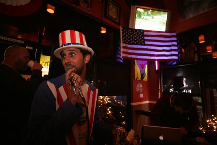 Showing off his patriotism, local poet Amir Rikkah speaks to a crowd during an Election Day party at the Canvas Cafe, 430 E. Silverado Ranch Blvd., on Tuesday.
