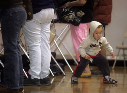 Alex Walker, 3, dances around the Boulder City Recreation Center gym Tuesday while his grandmother, Pat Johnson, votes.
