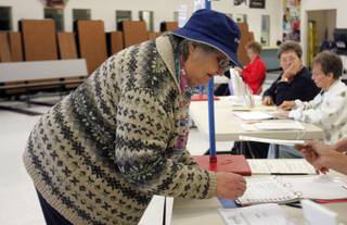 Sharon Moleton signs in to vote Tuesday at Elton M. Garrett Middle School in Boulder City.
