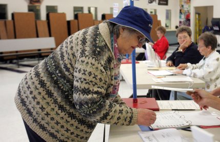 Sharon Moleton signs in to vote Tuesday at Elton M. Garrett Middle School in Boulder City.
