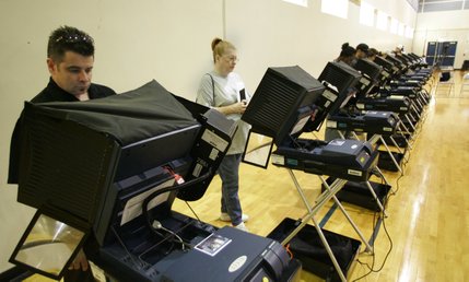 Jason Wood casts his vote Tuesday in the Basic High School gymnasium.
