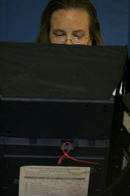 Stephanie Hall votes Tuesday in the gymnasium of Basic High School in Henderson.