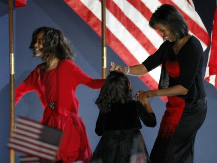 Michelle Obama escorts her daughters Malia, 10, and Sasha, 7, off the stage as President-elect Barack Obama begins his victory speech at his election night party at Grant Park in Chicago, Tuesday night, Nov. 4, 2008. 