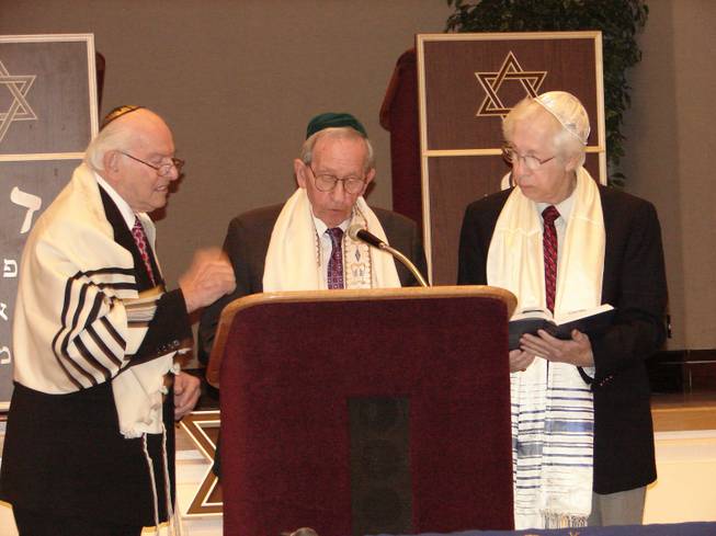 Rabbi Hershel Brooks joins Murray Silver and Irving Bonn during Silver's reading from an ancient Hebrew text.