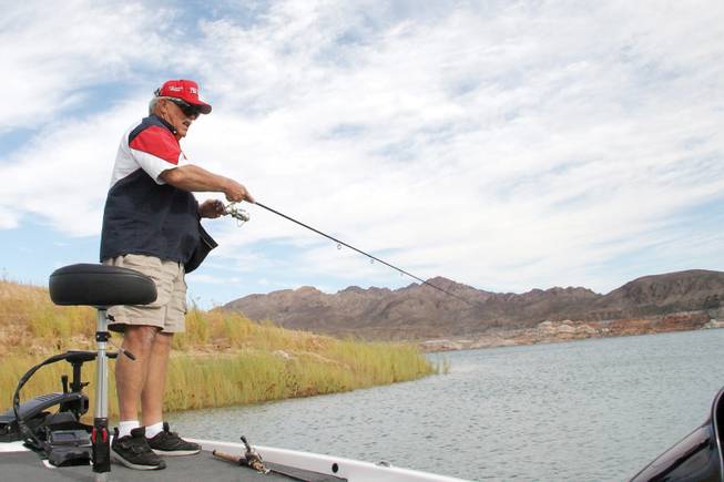 Local angler Mike Sisco holds his fishing pole while patiently waiting for a bite on Sunday at Lake Mead.