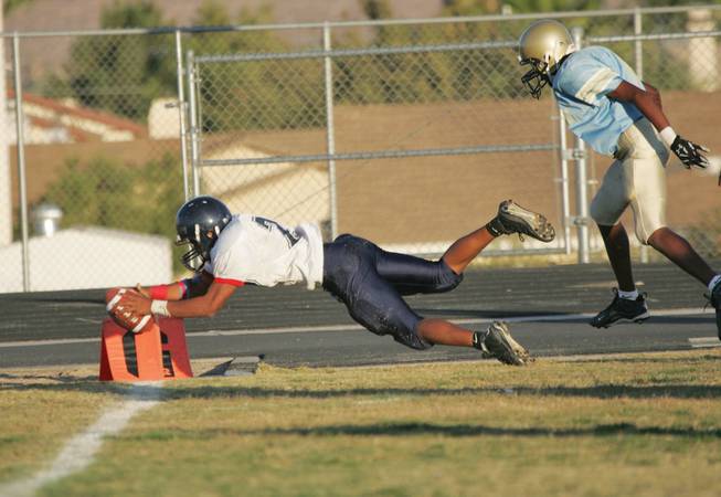 Coronado's Christopher Johnson dives Into the end zone during the final freshmen football game of the season at Foothill on Oct. 29.



