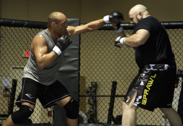 Mixed martial arts fighter Randy Couture, left, battles with Phil ...