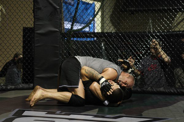 Mixed martial arts fighter Randy Couture, top, wrestles with Brice ...