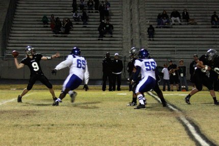 Palo Verde quarterback Kelly Zurowski (9) tries to pass the ball over incoming Sierra Vista defender Miles Harris (65).