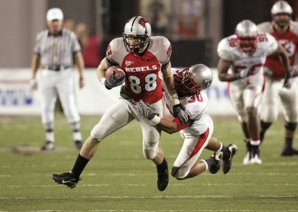 New Mexico's Ian Clark tries to pull down UNLV wide receiver Ryan Wolfe in the first quarter.