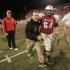 UNLV head coach Mike Sanford and offensive lineman Sifa Moala head to the band section to sing the school fight song after beating New Mexico 27-20 Saturday.