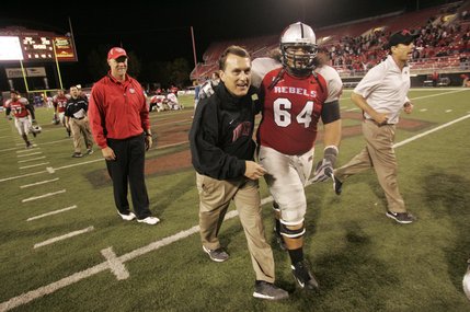 UNLV head coach Mike Sanford and offensive lineman Sifa Moala head to the band section to sing the school fight song after beating New Mexico 27-20 Saturday.