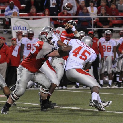UNLV quarterback Mike Clausen didn't have an easy time of it Saturday night against a New Mexico rushing defense that caused a misdirection of this pass. 