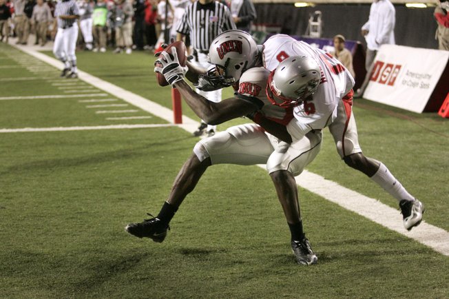 Despite the efforts of New Mexico cornerback Anthony Hooks, UNLV wide receiver Rodelin Anthony pulls in  touchdown pass on Nov. 8.