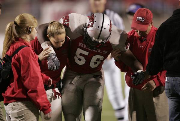 UNLV linebacker Ronnie Paulo is helped off the field after ...