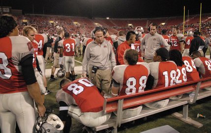 UNLV wide receiver coach Kris Cinkovich talks with his players after they came off the field during the first half.