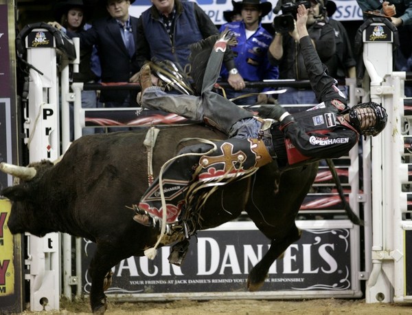 Bull riding at the final round of the PBR World ...