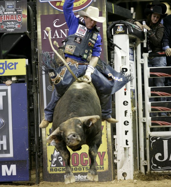 Bull riding at the final round of the PBR World ...