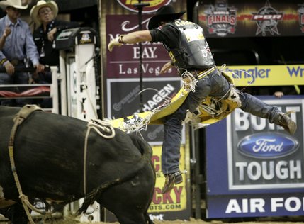 Bull riding at the final round of the PBR World Finals at the Thomas and Mack Center Sunday.  