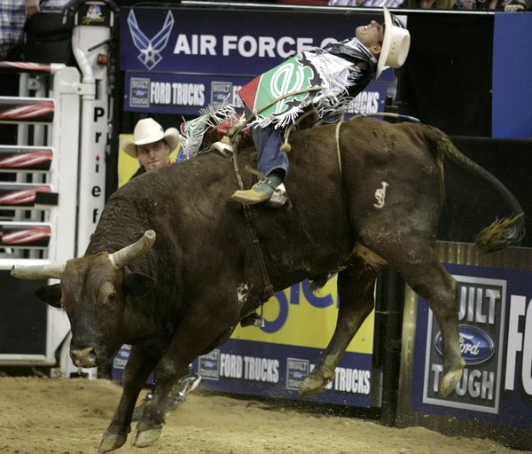 Bull riding at the final round of the PBR World ...
