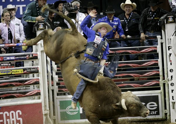 Bull riding at the final round of the PBR World ...