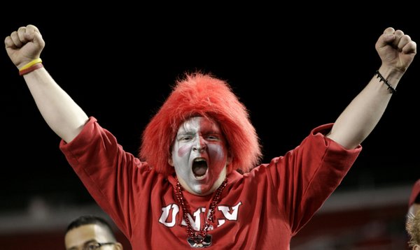 An avid Rebels fan cheers after a UNLV touchdown.