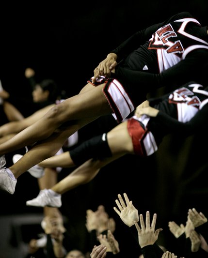 UNLV cheerleaders flip after a Rebels touchdown.