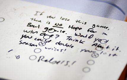 A white board with some motivational words sits behind the UNLV bench.