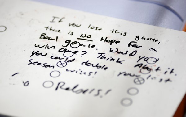 A white board with some motivational words sits behind the ...