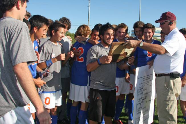 Head Coach Nick Arbelaez receives the championship plaque for beating Clark High School during the Sunset Regional boys soccer championship at Bettye Wilson Soccer Fields on Nov. 9, 2008.
