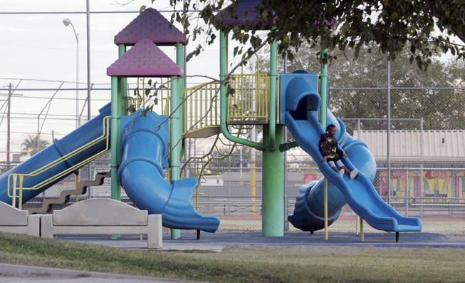 A child goes down a slide Monday in another part of the 18-acre park.