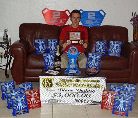 Blane Vadasy poses with his racing trophies.